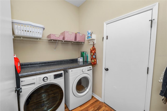 laundry room featuring laundry area, light wood-style flooring, baseboards, and washer and dryer