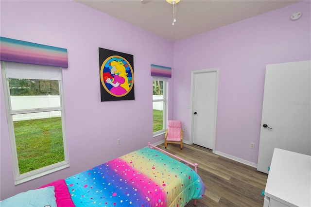 bedroom with baseboards and wood finished floors