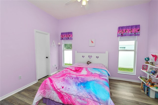 bedroom featuring wood finished floors, a ceiling fan, and baseboards