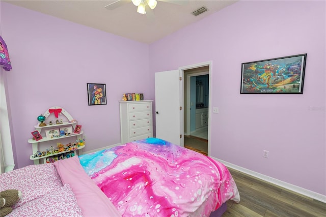 bedroom featuring a ceiling fan, visible vents, baseboards, and wood finished floors