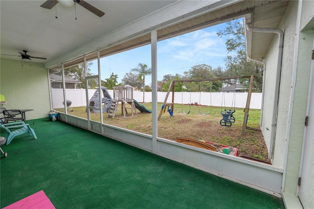 unfurnished sunroom with ceiling fan