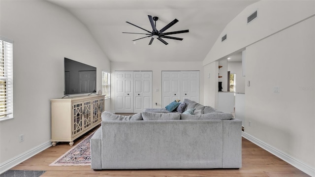 living room with a ceiling fan, baseboards, visible vents, and wood finished floors