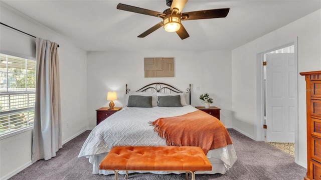 bedroom featuring a ceiling fan, light carpet, and baseboards