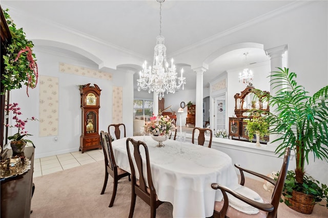 dining room featuring ornate columns, ornamental molding, light tile patterned floors, and a notable chandelier