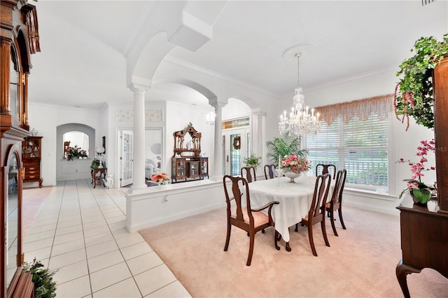 dining space featuring light tile patterned floors, arched walkways, decorative columns, and a chandelier