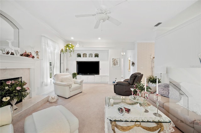 carpeted living area featuring visible vents, a high end fireplace, ceiling fan, ornamental molding, and recessed lighting