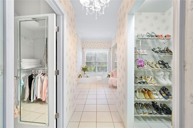 interior space featuring wallpapered walls, a chandelier, and tile patterned floors