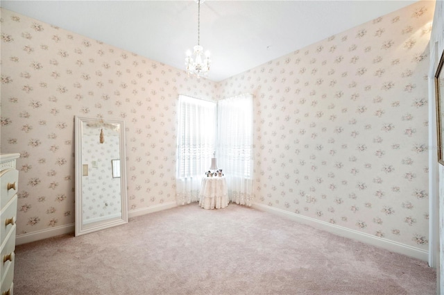 interior space featuring baseboards, carpet, an inviting chandelier, and wallpapered walls