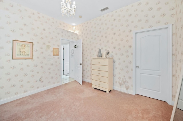 unfurnished bedroom featuring light carpet, wallpapered walls, and visible vents