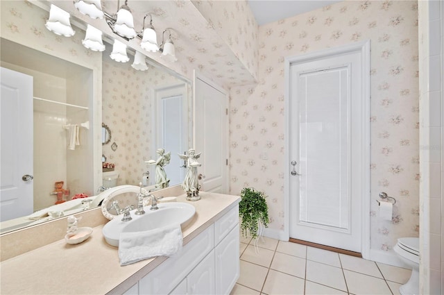 full bathroom featuring toilet, vanity, tile patterned flooring, baseboards, and wallpapered walls