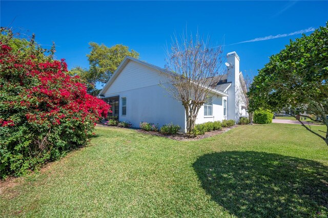 view of home's exterior with a yard and stucco siding