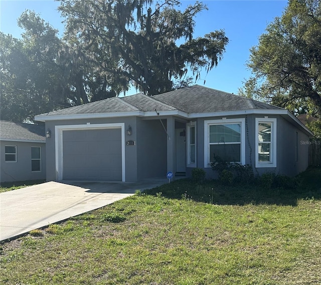 ranch-style house featuring a garage, a front yard, concrete driveway, and stucco siding