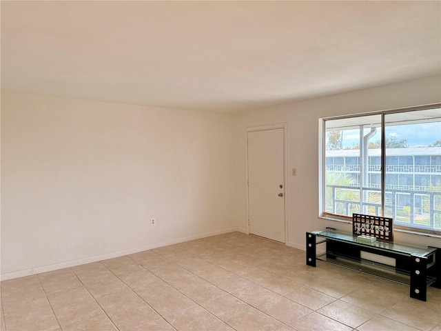 foyer with baseboards and light tile patterned floors