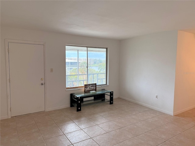 foyer entrance with baseboards and light tile patterned floors