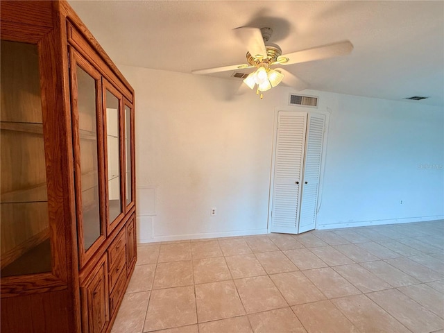 spare room with light tile patterned floors, ceiling fan, and visible vents