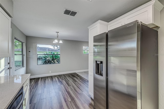 kitchen featuring stainless steel refrigerator with ice dispenser, a wealth of natural light, visible vents, white cabinetry, and light stone countertops