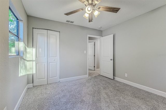 unfurnished bedroom featuring light carpet, visible vents, and baseboards