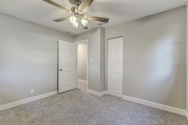 unfurnished bedroom featuring carpet floors, a closet, visible vents, and baseboards