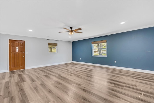 spare room featuring ceiling fan, recessed lighting, light wood-style floors, baseboards, and ornamental molding