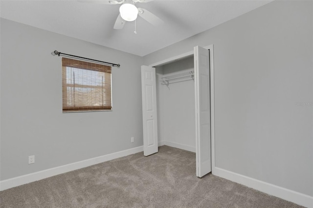 unfurnished bedroom featuring a ceiling fan, a closet, baseboards, and carpet flooring