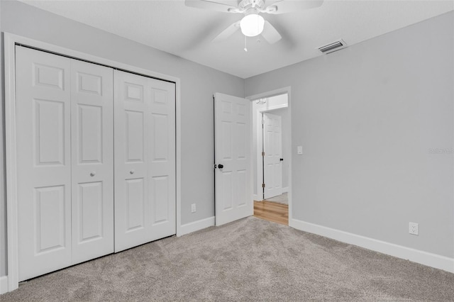 unfurnished bedroom with ceiling fan, carpet flooring, visible vents, baseboards, and a closet