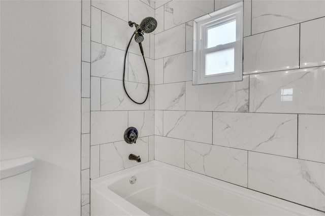 bathroom with tub / shower combination and toilet