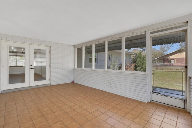 unfurnished sunroom with french doors