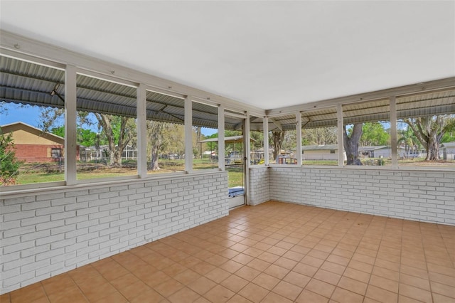 unfurnished sunroom with a wealth of natural light