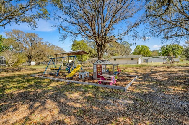 view of yard featuring a playground and fence