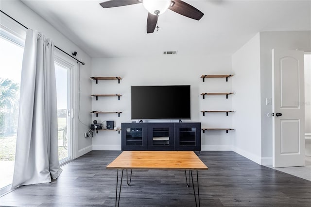 living area featuring ceiling fan, dark wood finished floors, visible vents, and baseboards