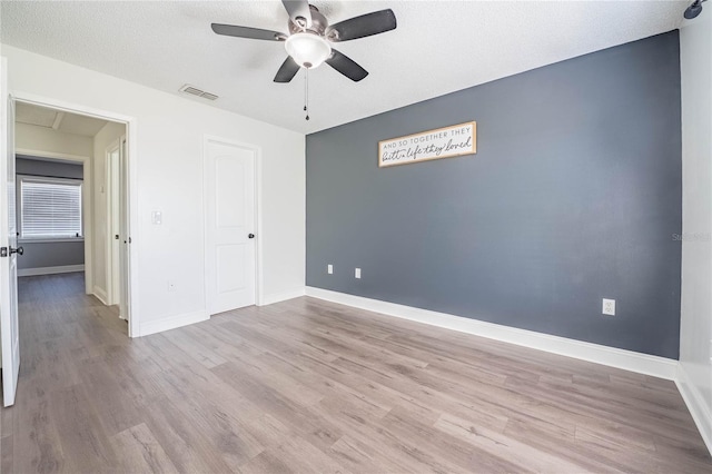 unfurnished bedroom featuring light wood-type flooring, baseboards, and visible vents