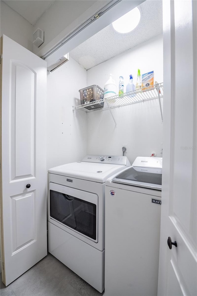 washroom with laundry area and washer and clothes dryer