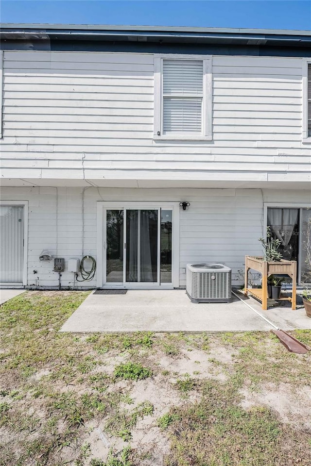 rear view of house featuring a patio and central air condition unit