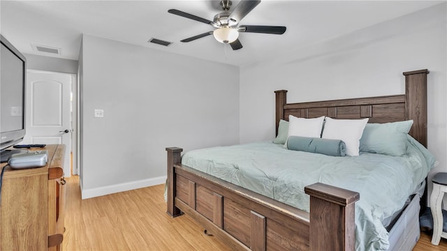 bedroom featuring visible vents, light wood-style flooring, and baseboards