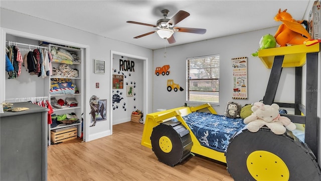 bedroom with baseboards, a ceiling fan, and wood finished floors