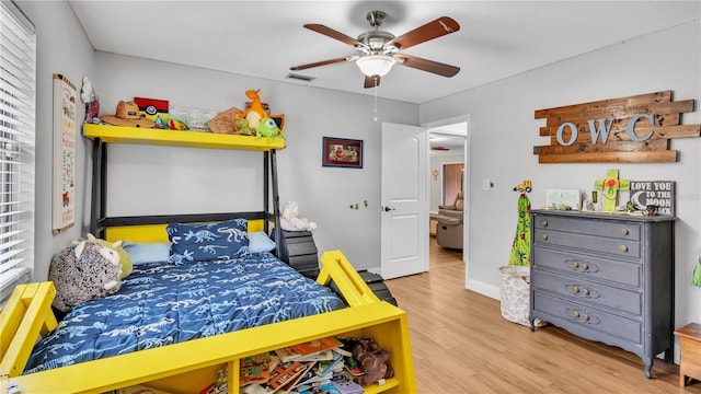 bedroom with visible vents, ceiling fan, baseboards, and wood finished floors