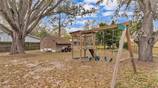 view of play area with an outbuilding, a fenced backyard, and a shed