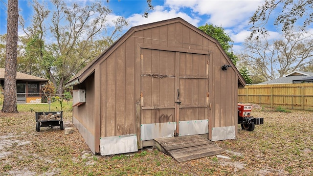 view of shed featuring fence