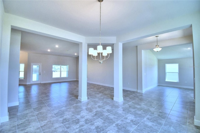 unfurnished dining area with baseboards, dark tile patterned floors, recessed lighting, and an inviting chandelier