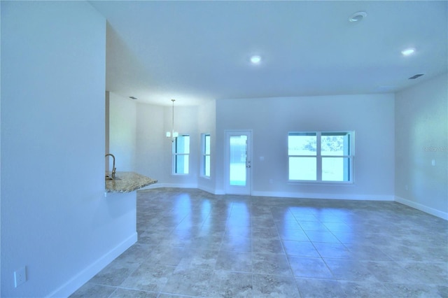 unfurnished room with light tile patterned floors, visible vents, baseboards, and recessed lighting