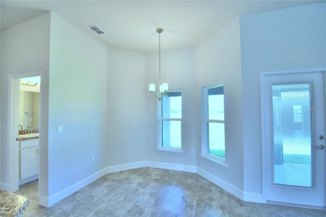 unfurnished room featuring an inviting chandelier, baseboards, light tile patterned floors, and visible vents