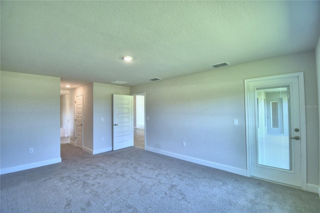 unfurnished bedroom with visible vents, dark carpet, a textured ceiling, and baseboards