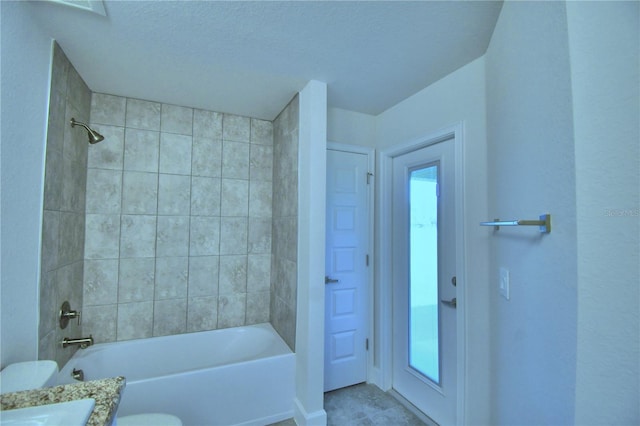 full bath with bathtub / shower combination, vanity, toilet, and a textured ceiling