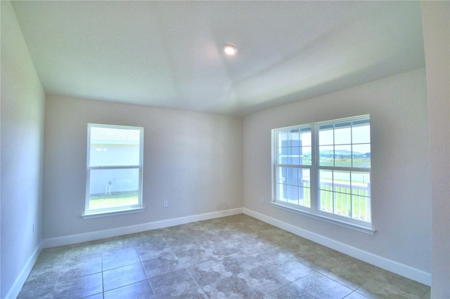 unfurnished room featuring baseboards