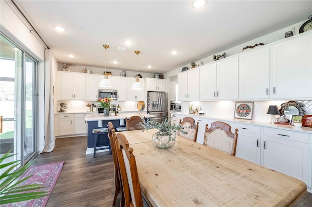 dining space featuring dark wood-type flooring, visible vents, and recessed lighting