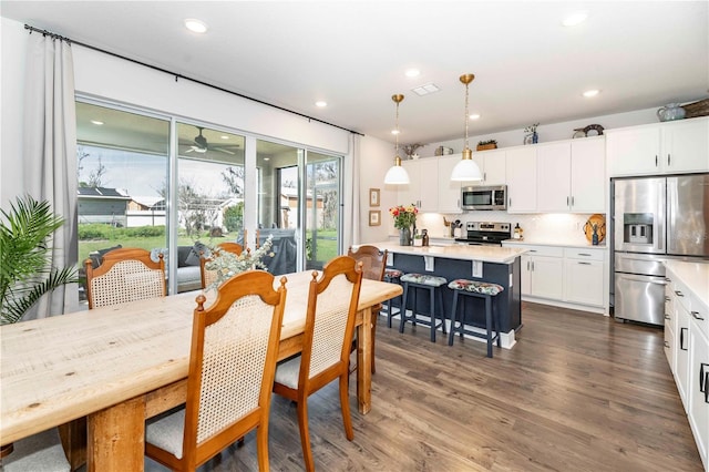 dining area with dark wood-style flooring and recessed lighting