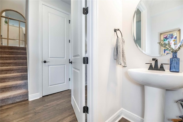 bathroom with baseboards and wood finished floors