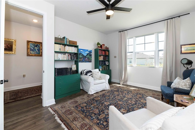 living area with ceiling fan, wood finished floors, and baseboards