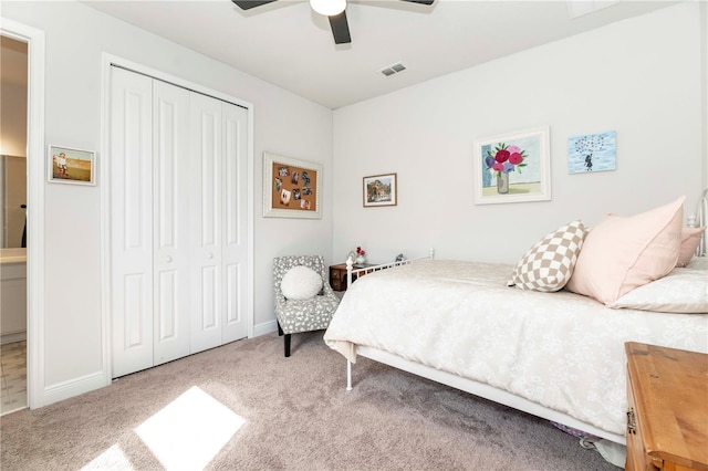 carpeted bedroom with a closet, visible vents, ceiling fan, and baseboards