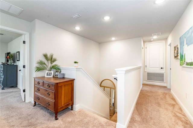 hall featuring light carpet, recessed lighting, visible vents, and an upstairs landing